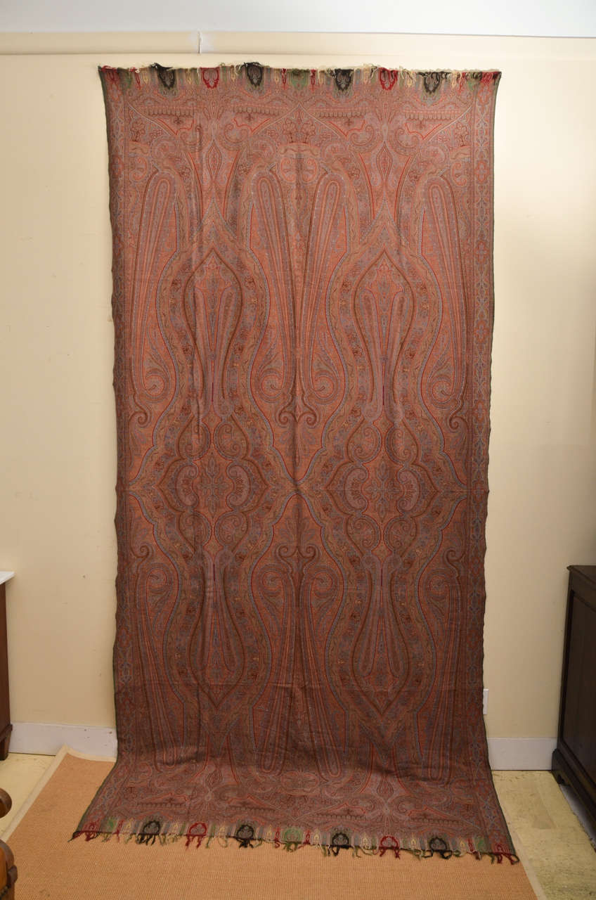 Rare large 12 feet by 5 feet Paisley shawl. In excellent condition. The shawl is woven with the tear drop symbol that is characteristic of paisleys, named in India as boteh, flower or mango. The European shawls were fashioned after the shawls of