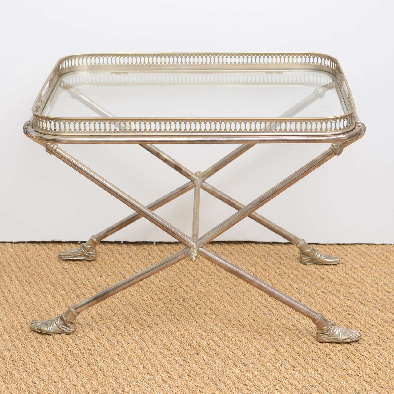 An exquisite and stunning original Fornasetti Gilt Silver cocktail table, with removable reticulated tray table top with inset flush mount glass top.  Table is  x-base frame, with center stretcher, with forged Romanesque sandal feet, footed feet,