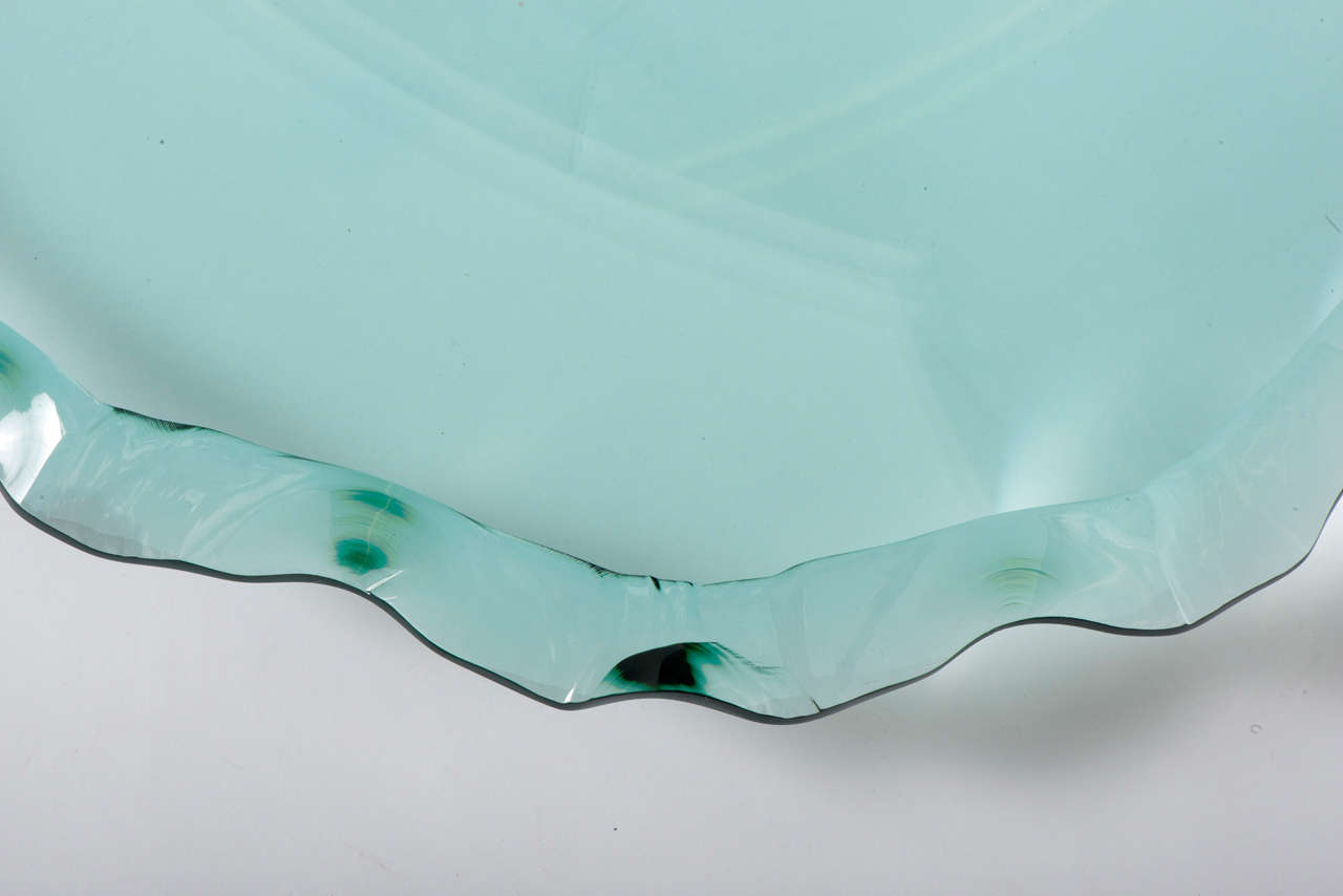 A Danny Lane tinted blue/green glass bowl.
“Broken Bowl.”
Heat formed float glass with fractured look edge.
England, 1998.
Signed; Danny Lane 2 of 15
Measures: 12 cm high x 62 cm diameter.