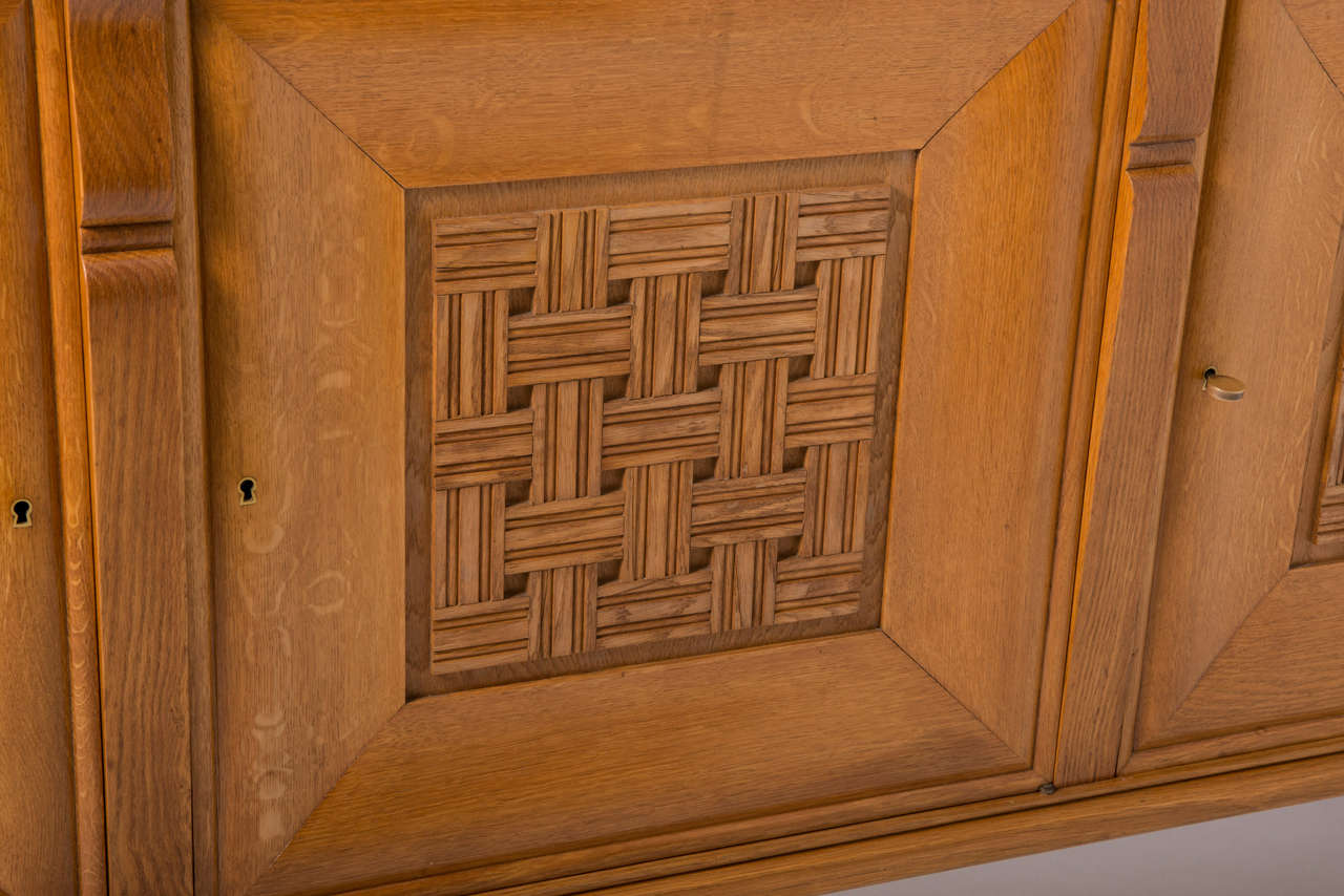An oak rectangular side cabinet.
Three doors centered by lattice work panels.
France, circa 1940.
Dimension: 197 cms W x 50 cms D x 97 cms H.