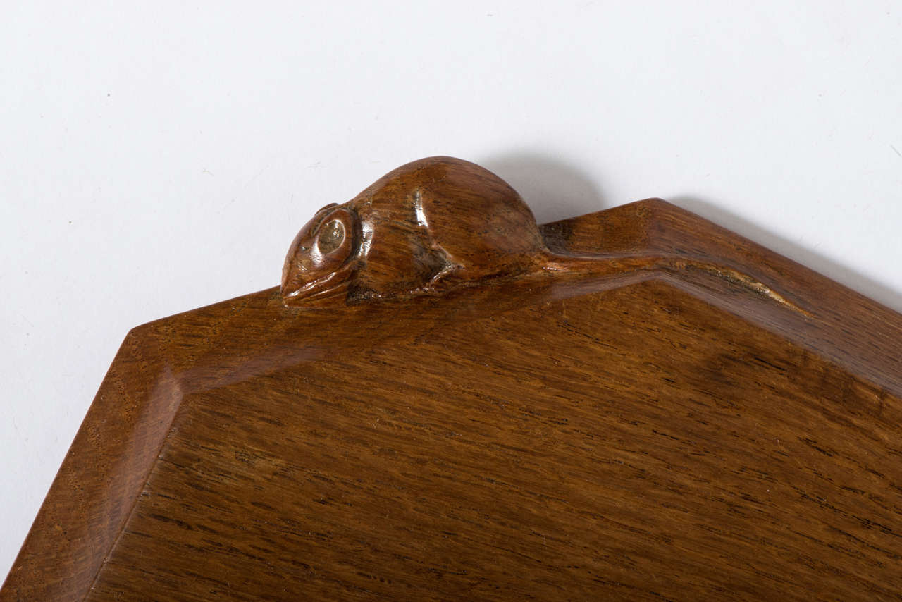 A Robert Mouseman Thompson oak chopping board of octagonal form.
Carved mouse to the side,
English,
circa 1960,
Measures: 3cm high x 31cms wide x 25 cms deep.