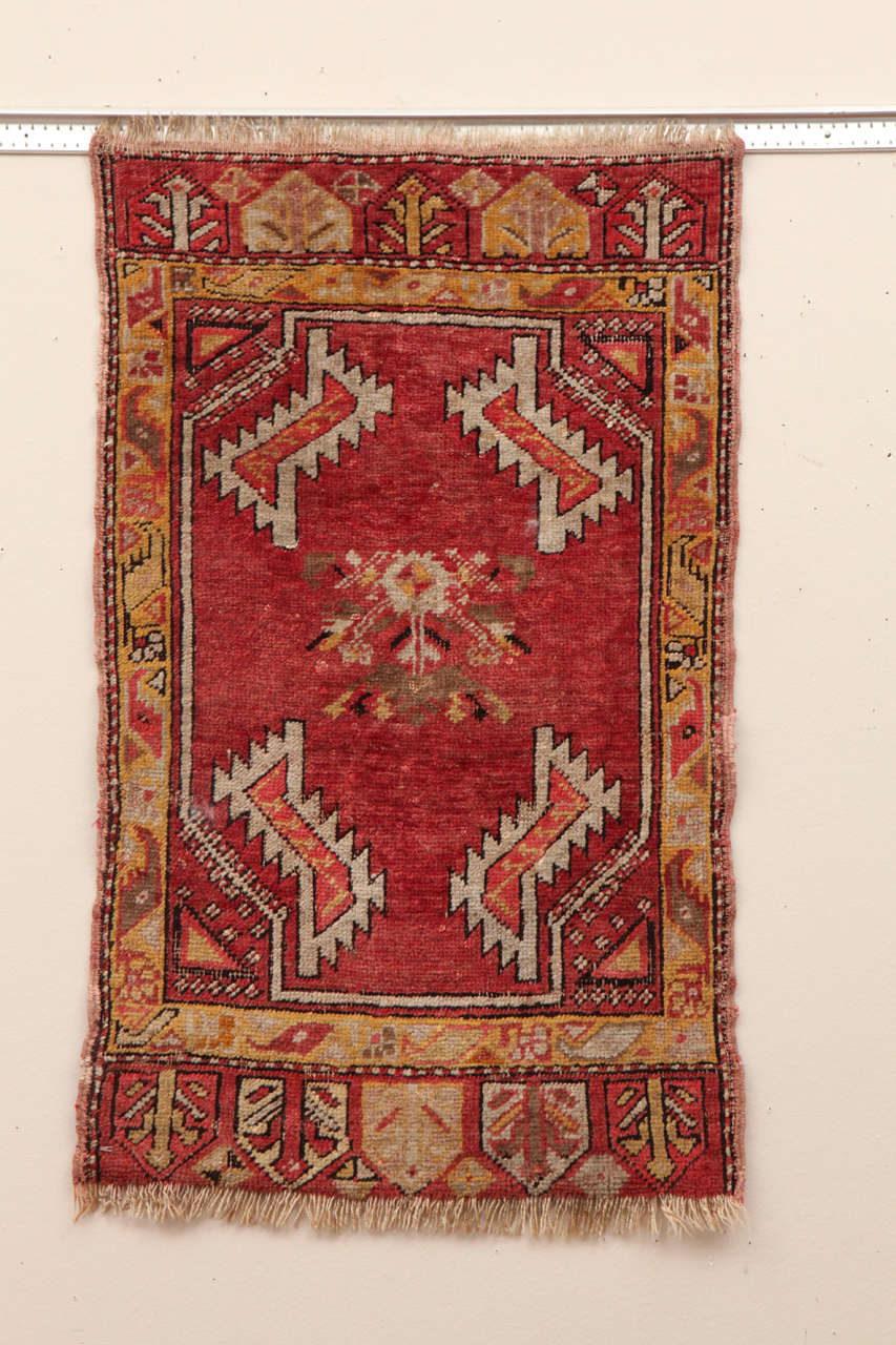 Early 20th C.  Good pile.  Charming small Turkish rug.  Yellow, red, ivory and olive green.