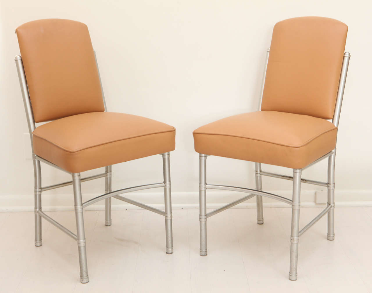 Four WM carmel colored leather dining chairs with chrome legs