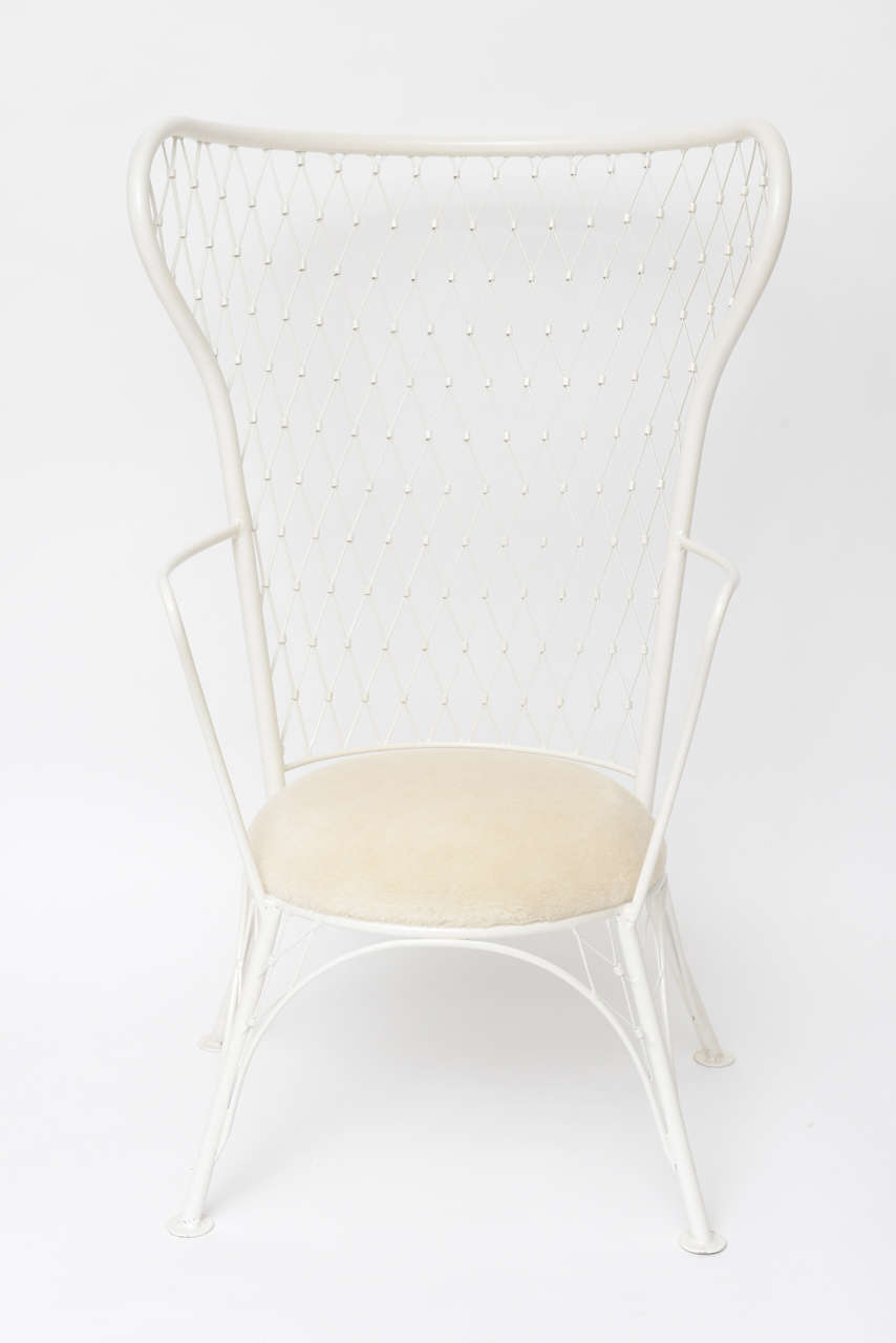 We're absolutely charmed by the quirkiness of this 1960s latticework wingback chair. White powder-coated metal with a faux mouton cushion. Suitable for outdoor use (but we love it indoors)!