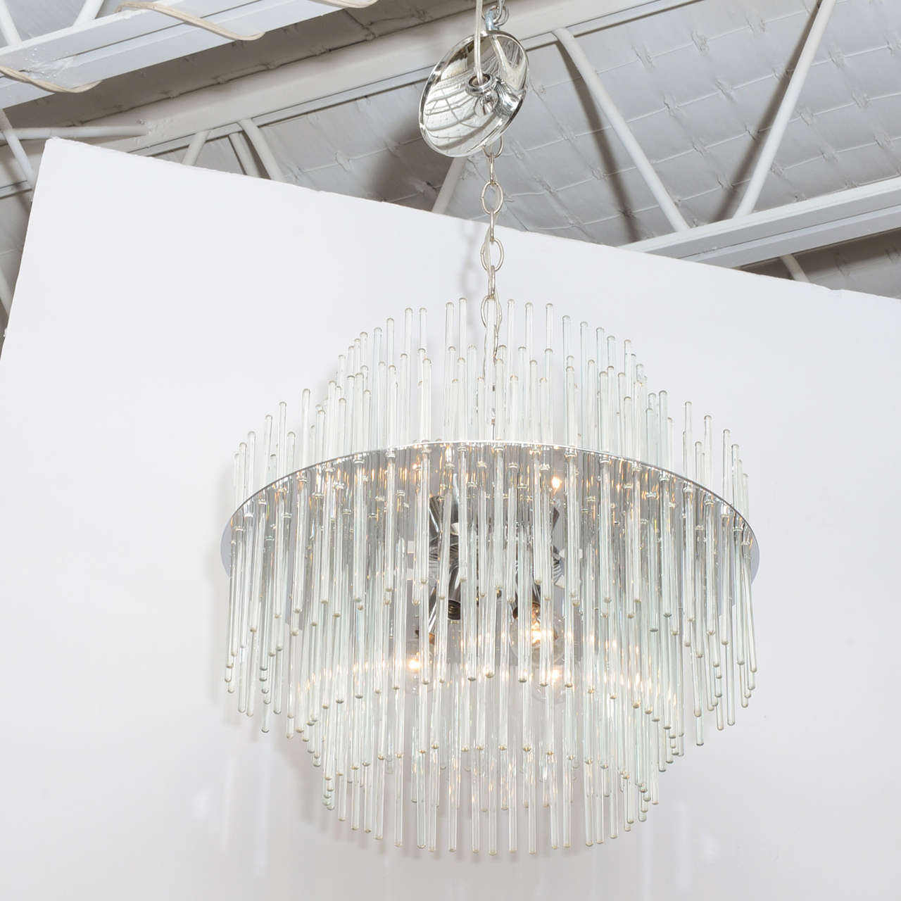 A Lightolier chandelier, designed by Gaetano Sciolari. handblown glass rods are suspended through a chrome frame, creating an especially enchanting effect after dark!