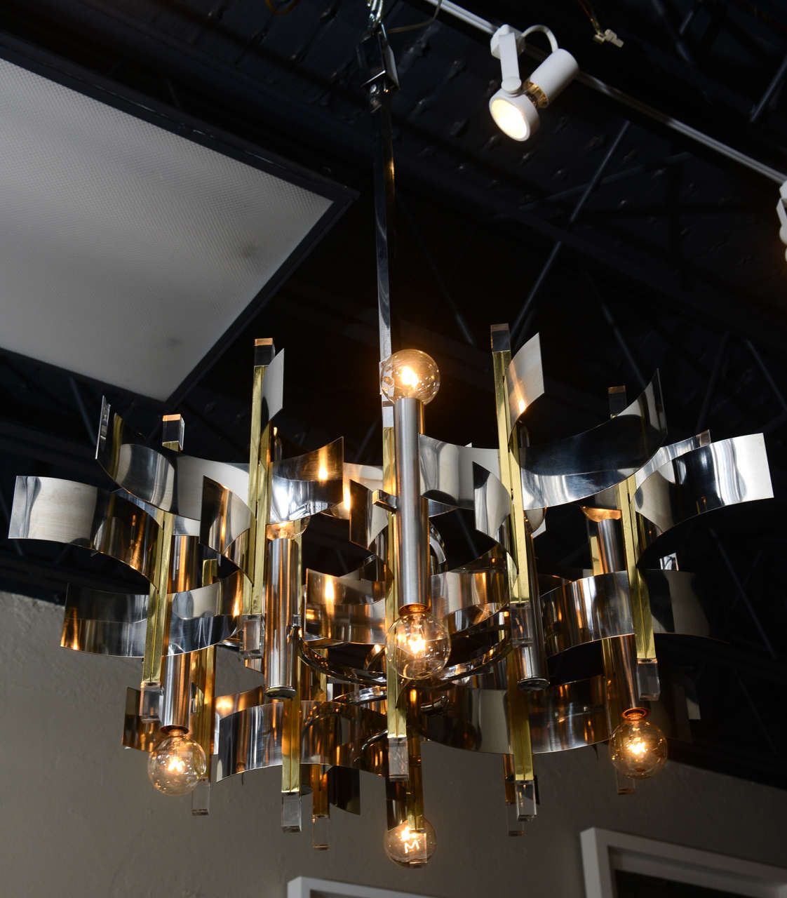Sparkling and lovely… 12-light chrome, brass, and lucite chandelier by Gaetano Sciolari.  Height measurement below includes 25