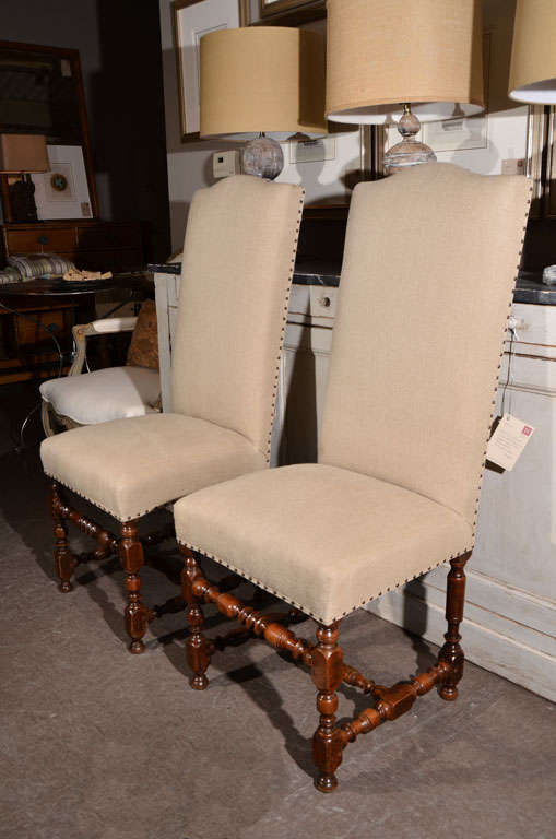 Pair of side chairs with crisply turned walnut legs and stretchers, from the period of Louis XIV, circa 1715. Joints strengthened, new upholstery using natural hemp, with nailhead trim.