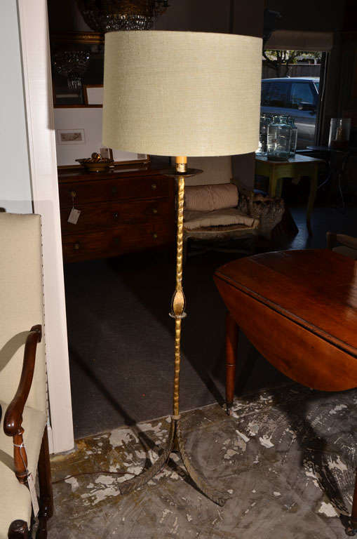 Gilt iron floor lamp with dimpled column, acanthus leaves at the center, splayed tripod base.  Circa 1940, France. (Rewired) Sage or oyster burlap lampshade sold separately, please inquire.