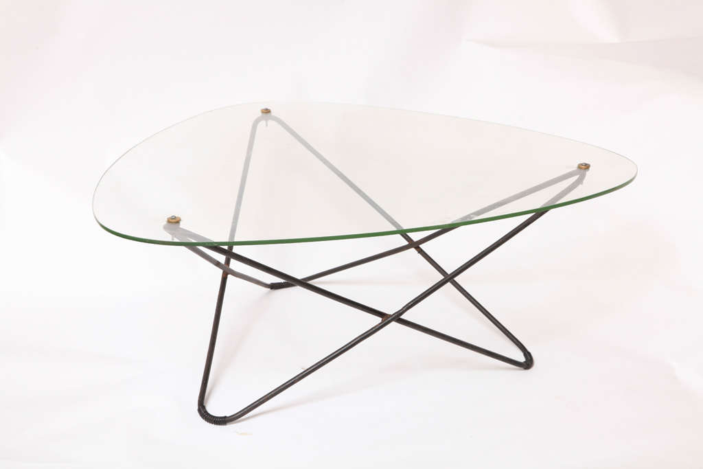 Outstanding vintage French atomic modern coffee table. This coffee table has a black painted steel base with brass fittings and the original glass top- please note the mold marks in the glass.
A fantastic addition to one's collection of designer