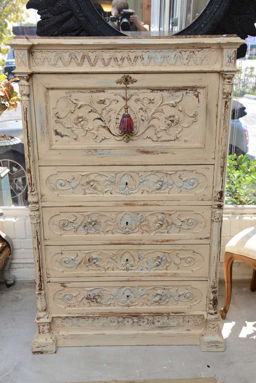 Very nice hand painted chest of drawers with a writing desk to the top drawer.To the front it has superb carving with carved pillars to each side.The drawers are solid wood with dovetail joints.
The desk interiors is satinwood with a secret