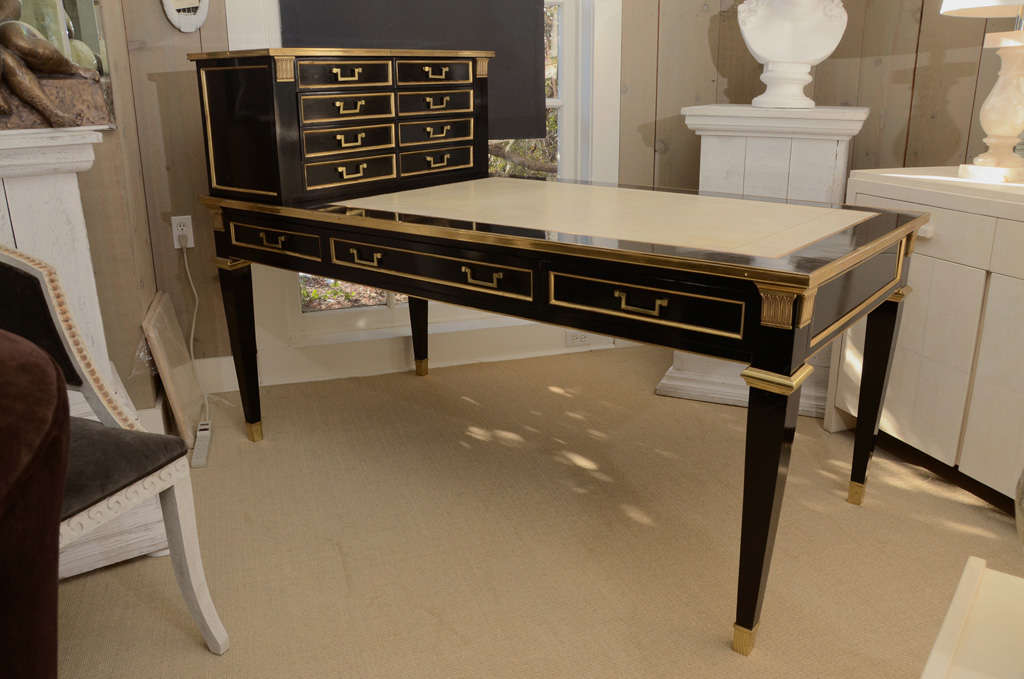 Spectacular French gilt metal mounted black lacquered bureau cartonnier (desk) by Jansen. The desk has a white leather top and was done in 1968.
The height of the writing surface is 30 in