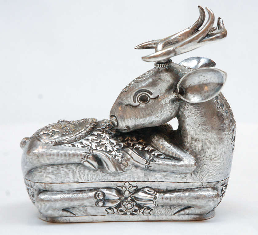 A beautiful turn of the century sterling silver stag box with intricate patterning and detail.