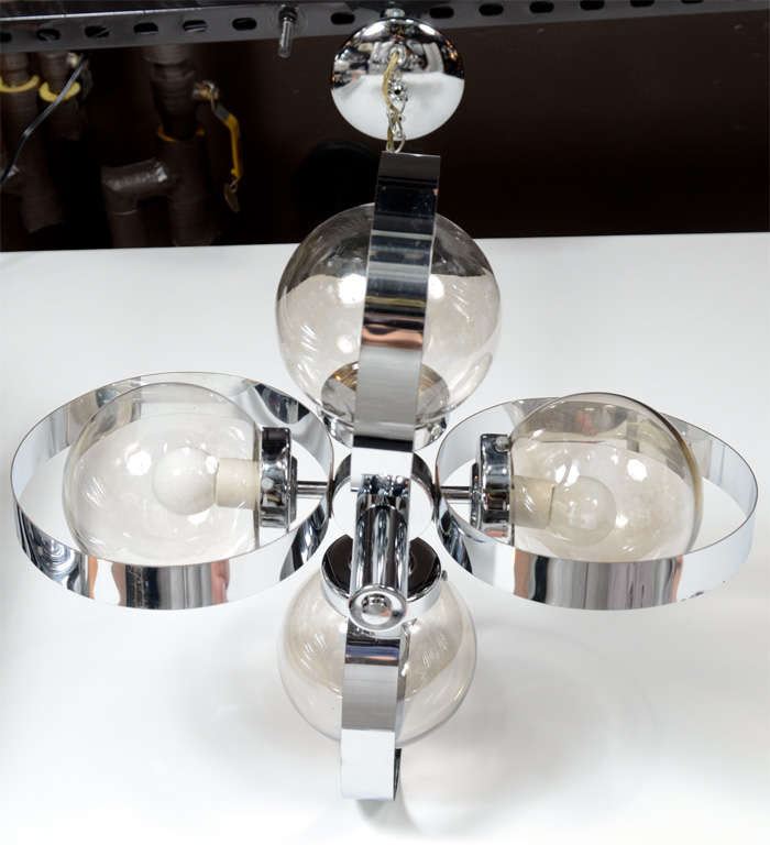 Modernist Mid-Century chandelier with stylized spherical quad form. Chrome stem with chrome banded spheres and with smoked glass globes. Fitted with four lights. Height with Chain is 30.5