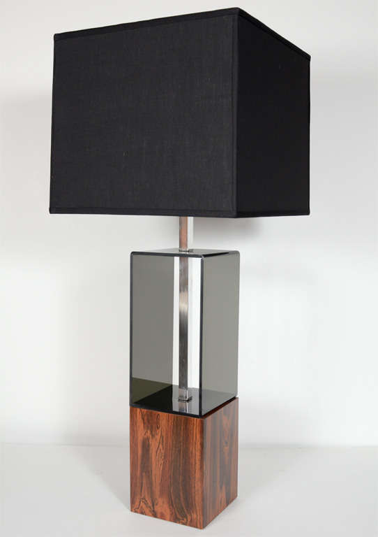 Pair of modernist lamps with styilzed smoked grey lucite form and with cubed wood pedestal bases. Lamps have a center chrome stem and fittings, and are shown with black linen cube shades.