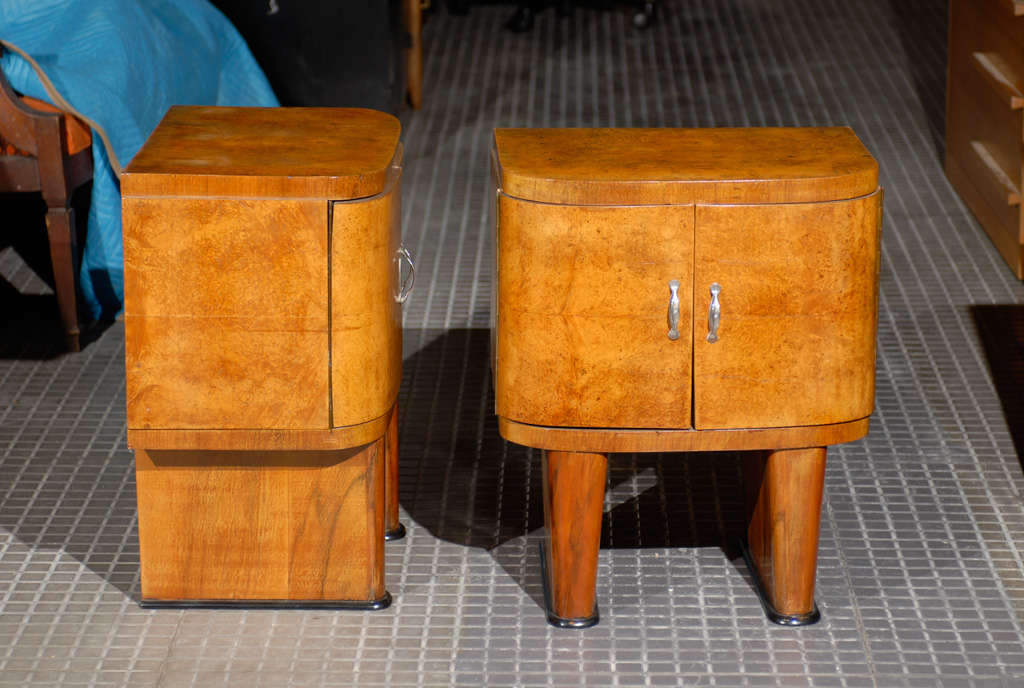 A stunning pair of French Art Deco small cabinets in book matched walnut, circa 1940.  A great size, the pair may function as end tables or night stands. Excellent Restored Condition. The pieces have been professionally cleaned and re-lacquered. The