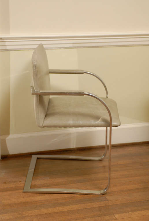 Great pair of Brayton International chrome flat bar armchairs.  Excellent Restored Condition, with new leather. There are currently four (4) chairs available. The price noted is for a pair.