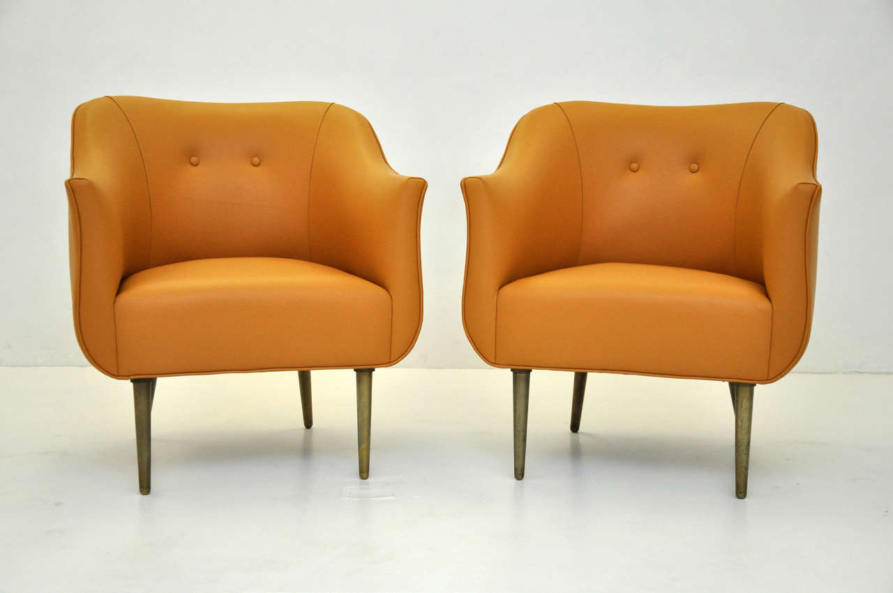 Rare lounge chairs by Edward Wormley for Dunbar.  Newly upholstered in butterscotch leather.  Heavy solid brass legs with a nice light patina.