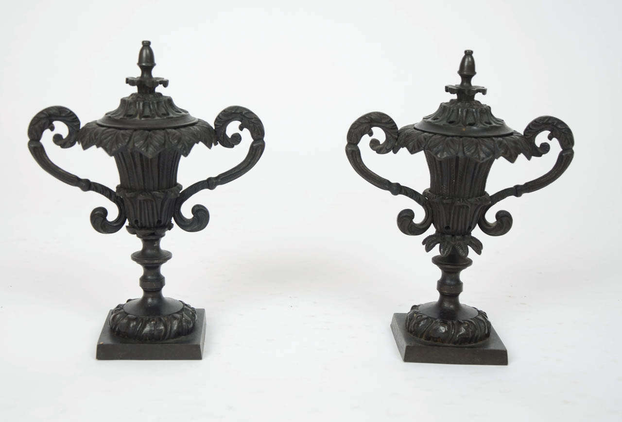 Pair of Regency bronze perfume burners of twin-handled urn form with pierced covers.