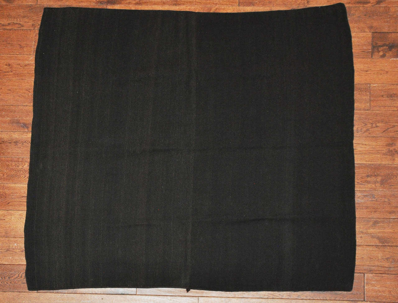 Worn by the Aymara peoples of Bolivia during mourning. This rare early 20th century piece is made of over dyed black sheep wool.
