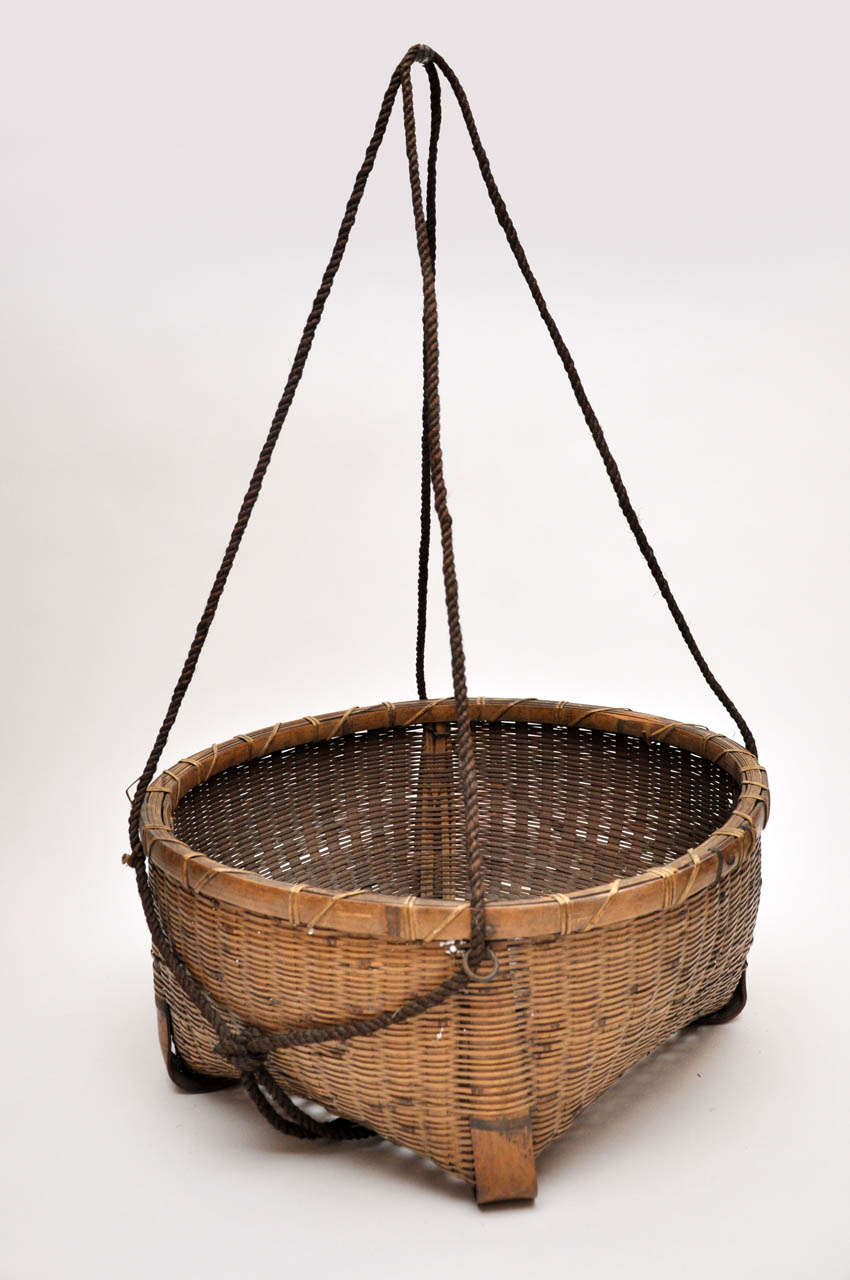 20th century Japanese fishing basket. Beautifully woven with long rope handles. Handles extend approximately 2 feet past the top of the basket.


Dimension: 10.25