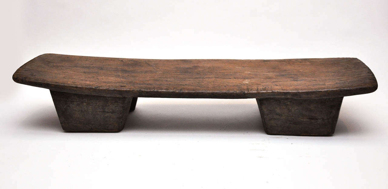 Small, hand-carved wooden bench from Nigeria. This would work well as a low bench or stool.
