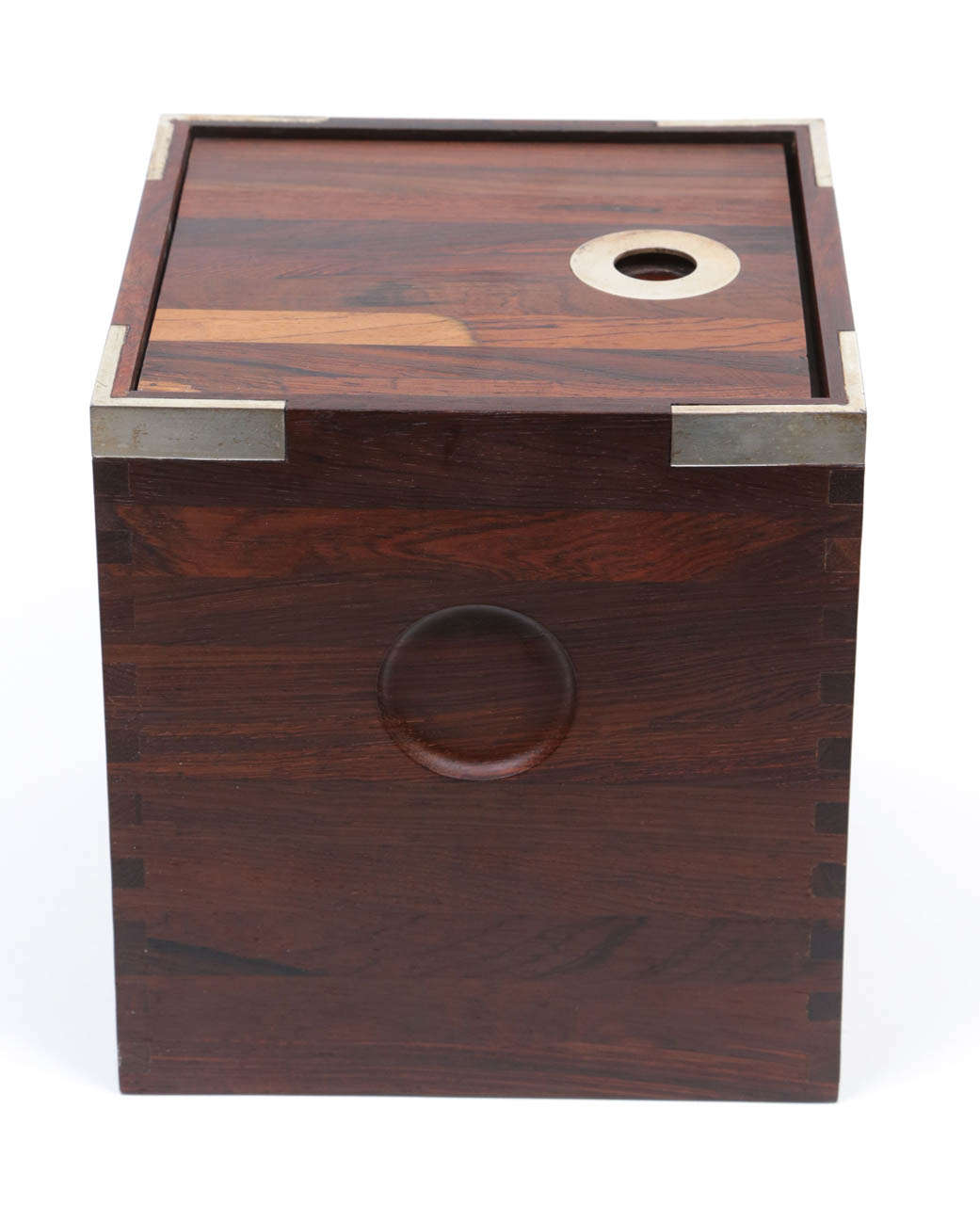 A rare cube-form ice bucket made from old-growth Brazilian rosewood, with finger-jointed sides and silver-plated corners and finger-lift.  Designed and produced by Richard Nissen, maker of all the wooden pieces for Dansk Designs.