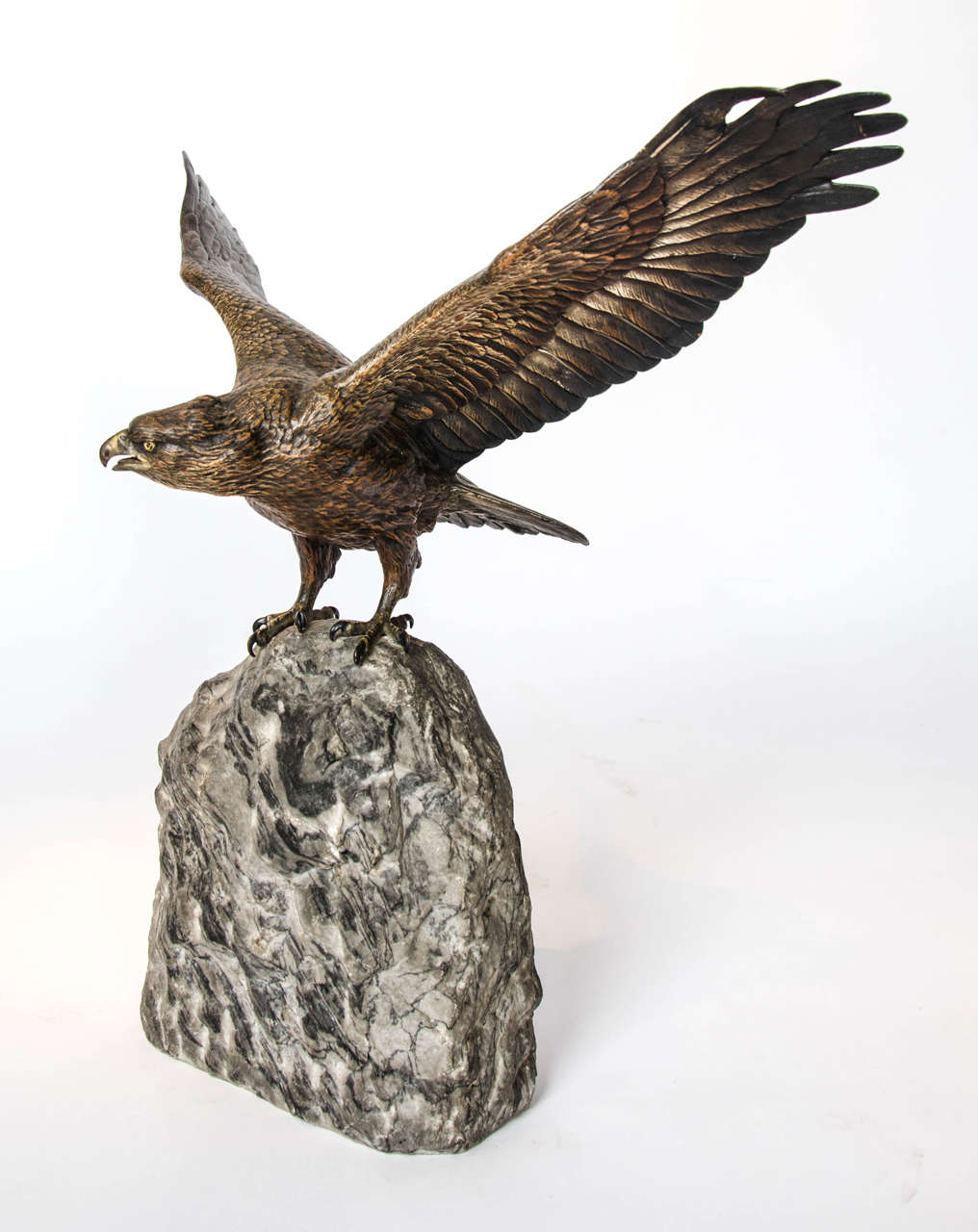 A cold painted bronze study of an eagle by Franz Xavier Bergman (1861-1936). Set atop a natural marble base, this eagle stands with wings outstretched. Fabulous detail, in wonderful original condition, some slight wear to the cold paint in