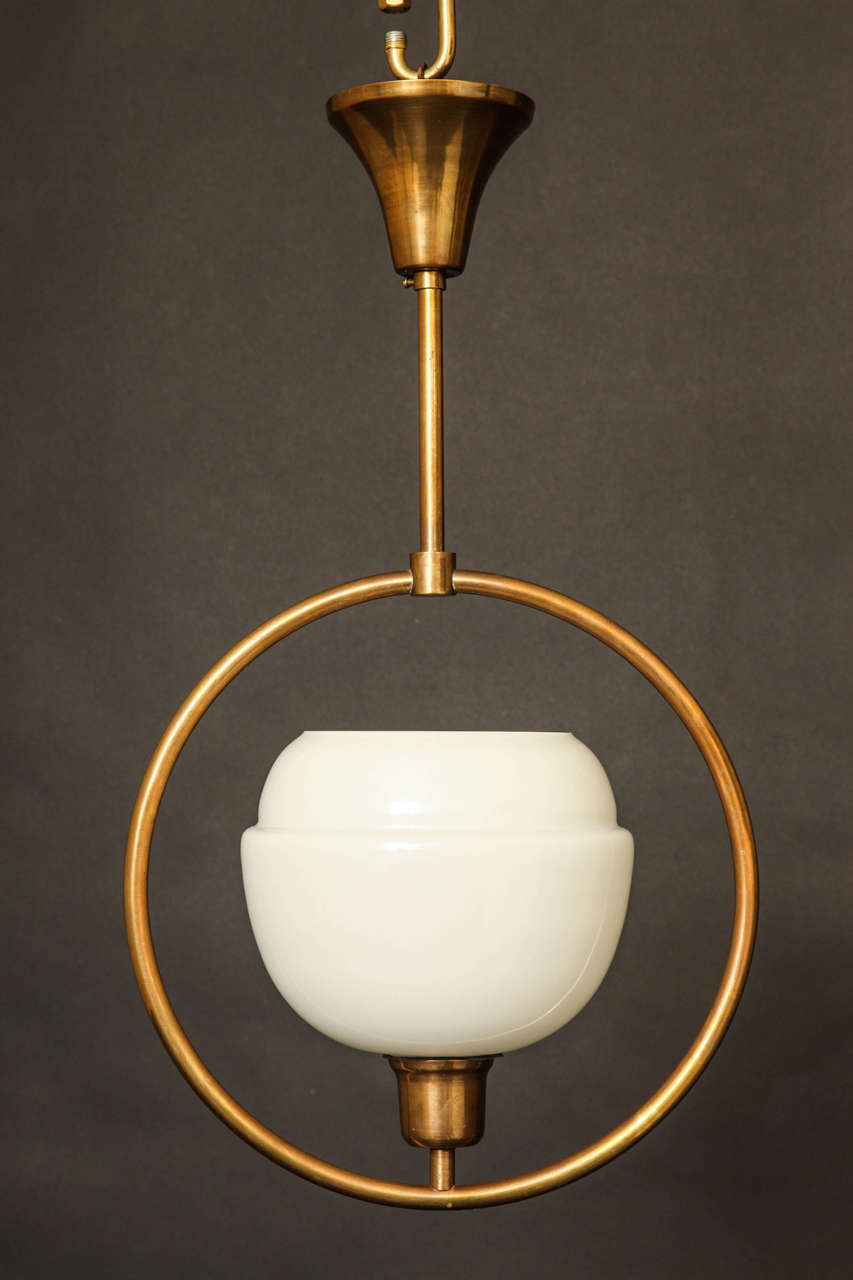 Brass Ring Pendant With Perched Opaline Glass Shade. The Pendant Supports A One Light Socket.