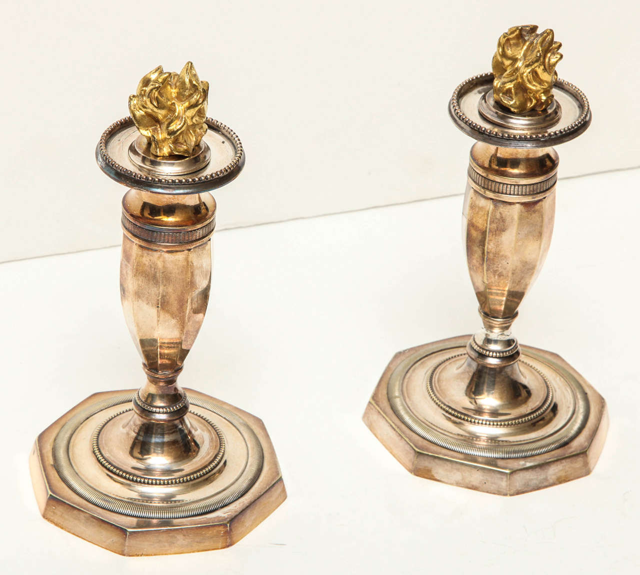 French Pair of Silver Directoire Candlesticks with Gold Flames For Sale
