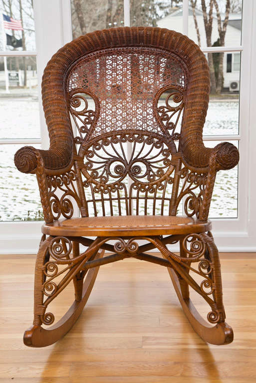 Elegant Victorian rocker in natural honey toned finish.