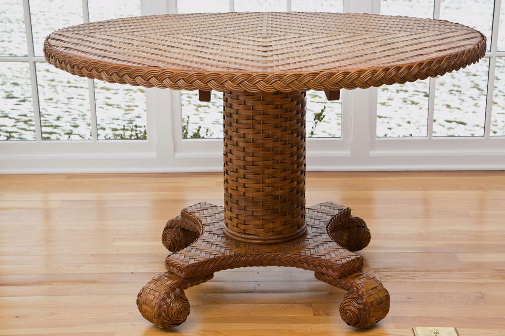 Large wicker center pedestal table in natural finish. Beautifully woven top and base in herringbone pattern.