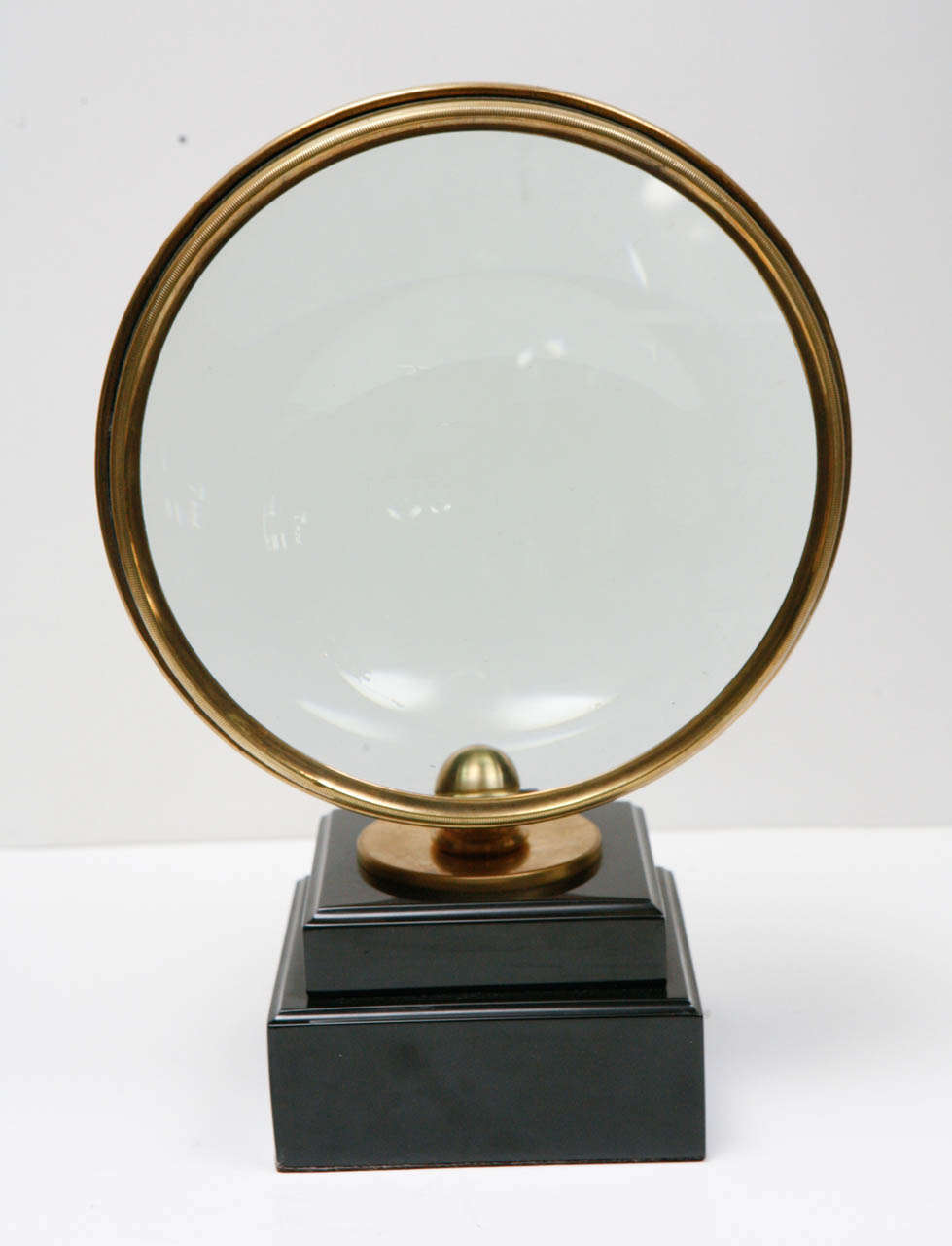 Large Brass Encased Magnifying Glass on Tiered Marble Stand.