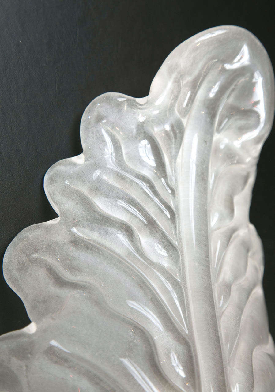 A stunning pair of shimmery opaque Murano blown leaf sconces with silver hardware.  Light can be illuminated with an 11 