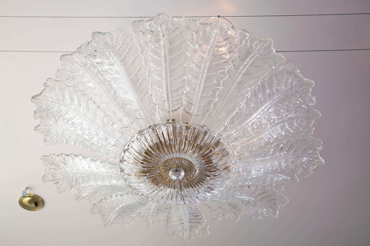 Very large pair of stunning textures Murano blown fixture each comprised of 18 beveled and textured leaves, a reeded and scalloped center bowl and clear blown toupie, each light contains 6 lights of up to 60 watts.