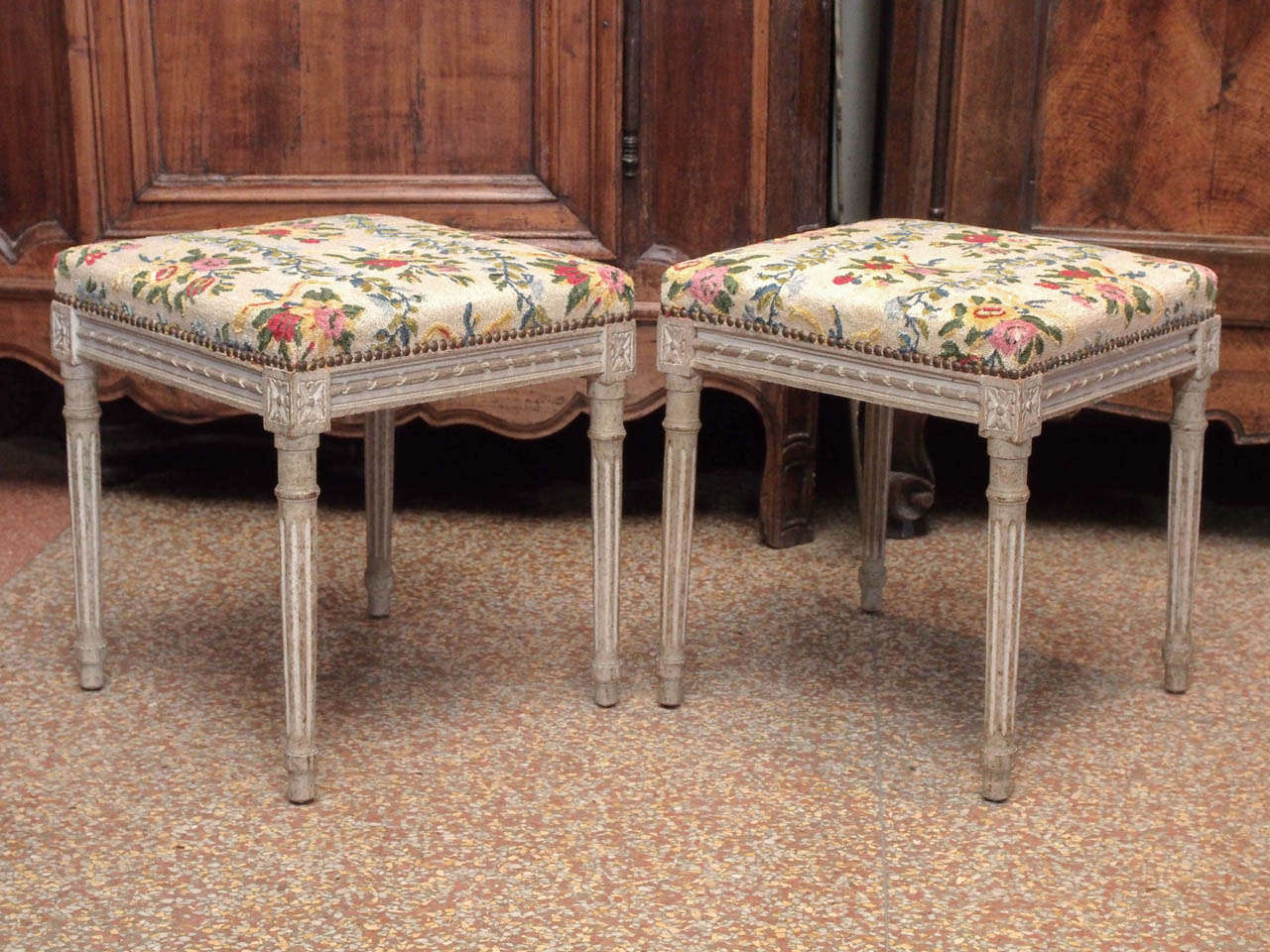 Pair 19th century Louis XVI painted stools with petit point upholstery.