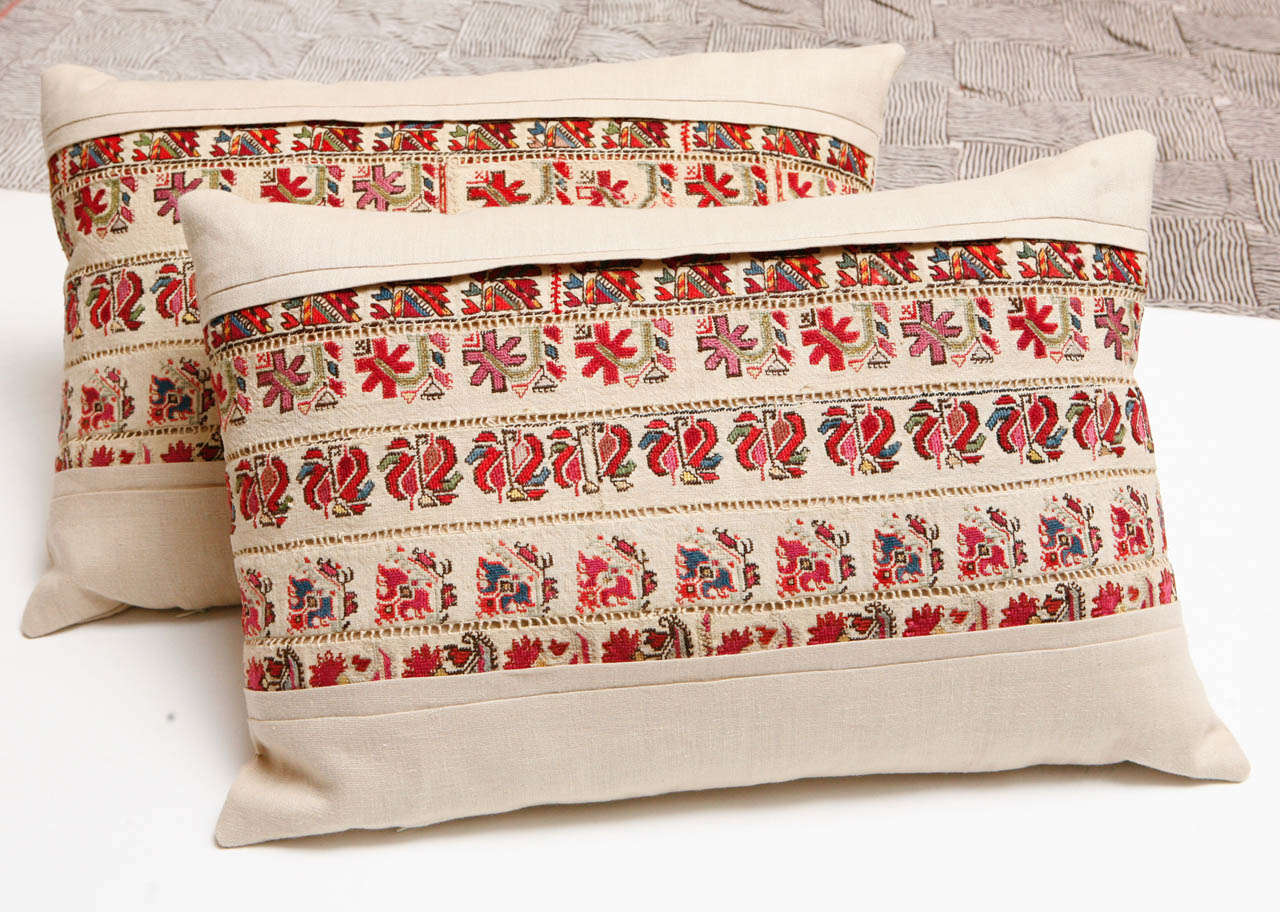 Early 20th C. Hand embroidered strips with pull work between each row.  Cotton floss on linen.  Inset into and backed with natural linen.  Invisible zippers.  Feather and down fill.  Priced individually at $ 850 each.