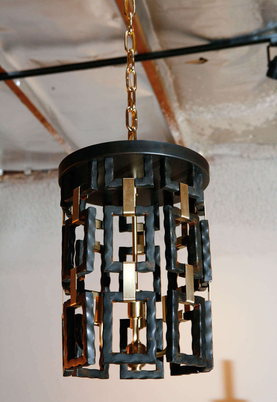 Modern Paul Marra link fixture shown as pendant in brass and oil rubbed bronze finish, hung by brass chain and canopy. One pendant is in stock as shown. Four-light candelabra, max 60 watts each. Brass chain and canopy.
