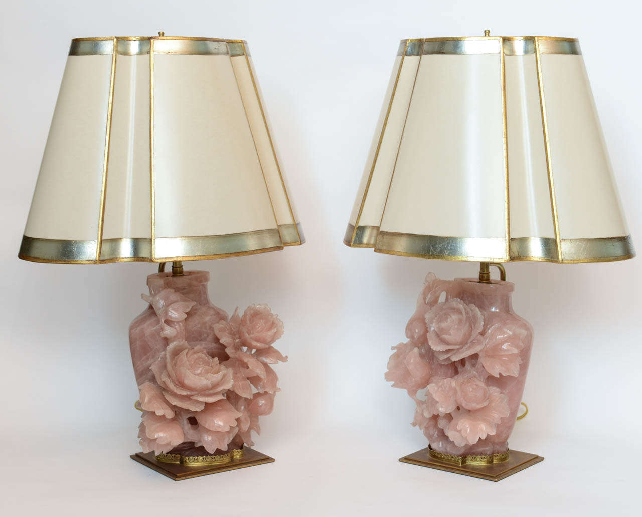 A pair of carved rose quartz Chinese vases with flowers.