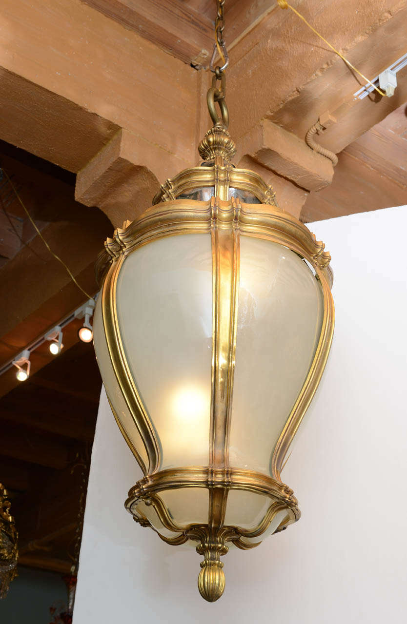 An exquisite and massive gilt bronze and frosted glass lantern by E.F. Caldwell, circa 1900.