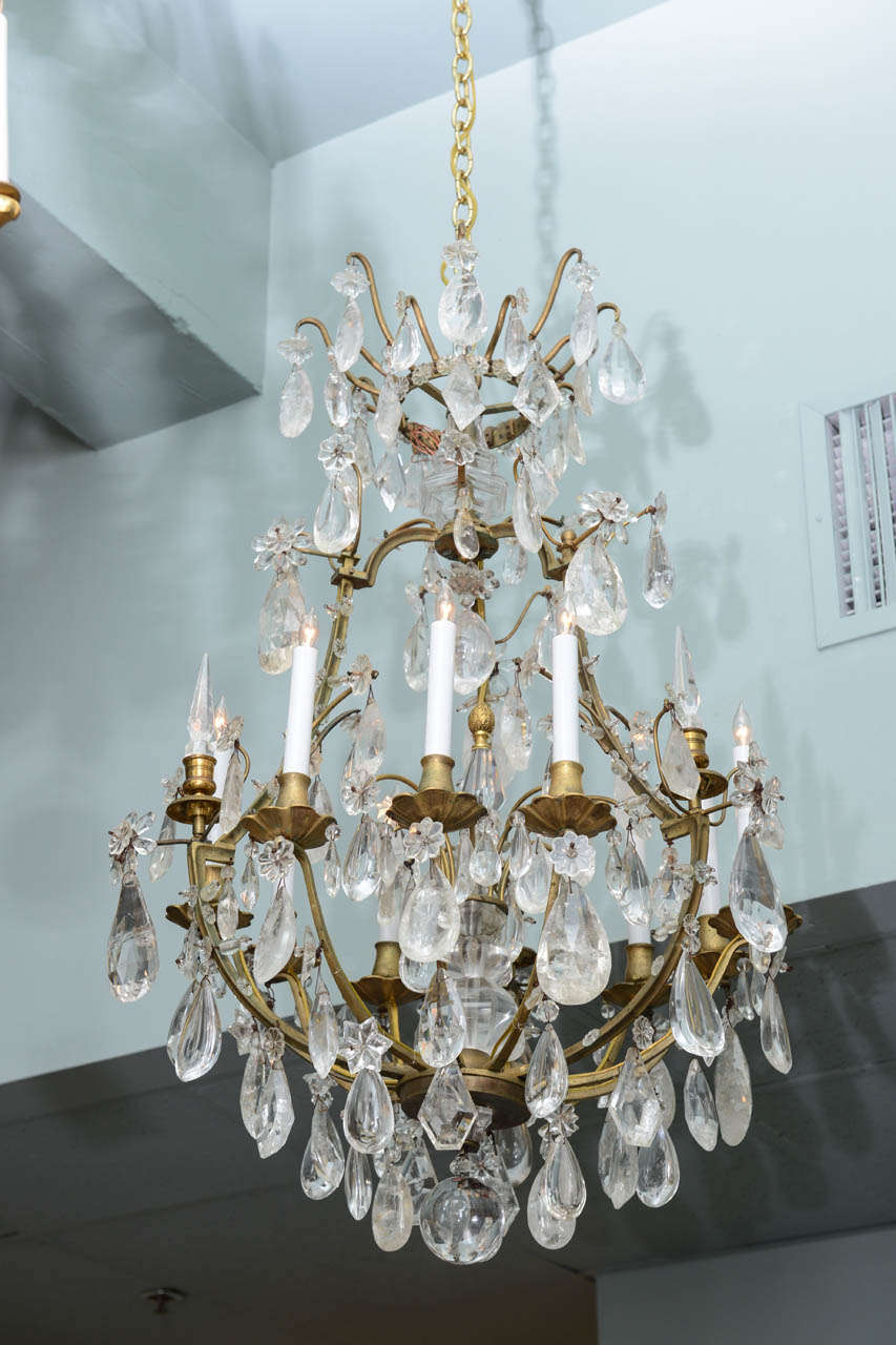 A French gilt bronze chandelier with elaborate center mount rock crystal and multi faceted cut drops, circa 1870.