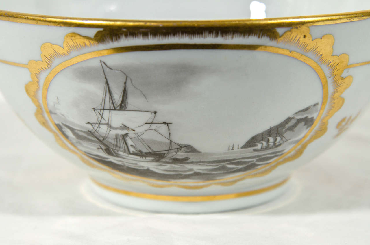 A small early 19th century English porcelain bowl with scenes painted in grisaille. The scenes show: a ship at sea, a thatched cottage and a landscape with manor house (see images).