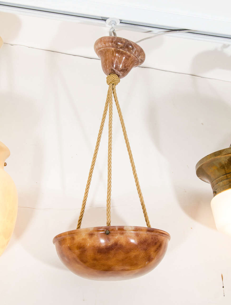 A Classic shape, the tortoise-toned alabaster glows from its satiny finish and its one 60 watt equivalent LED bulb. Recently rewired with three electrified ropes, the fixture features a matching alabaster canopy.

Custom rewiring to your specified