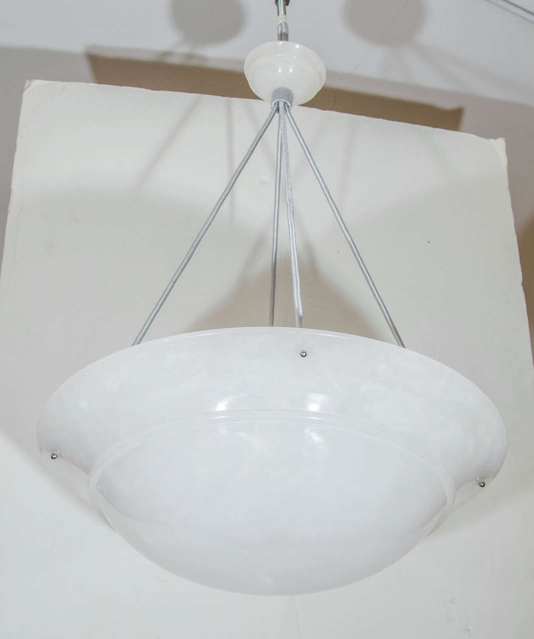 A sleek white fixture with no mineral veining, whose sole decoration is a 1/2 inch, carved band around the midsection from whence the fixture reaches outward and elegant chrome hardware. 

Custom drop on silk ropes included; chain can also be