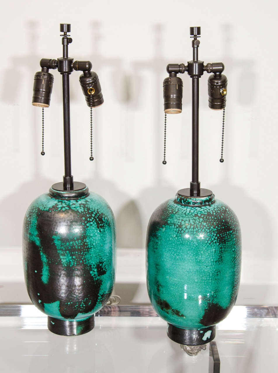 Pair of French Primavera au Printemps green/blue/black glaze ceramic lamps.