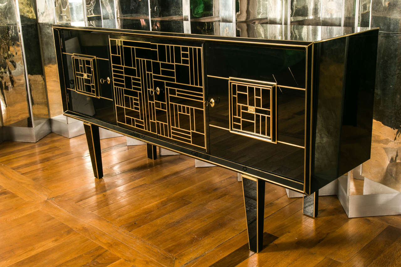 Black mirror vintage sideboard, brass geometric decoration, front opening by four doors.