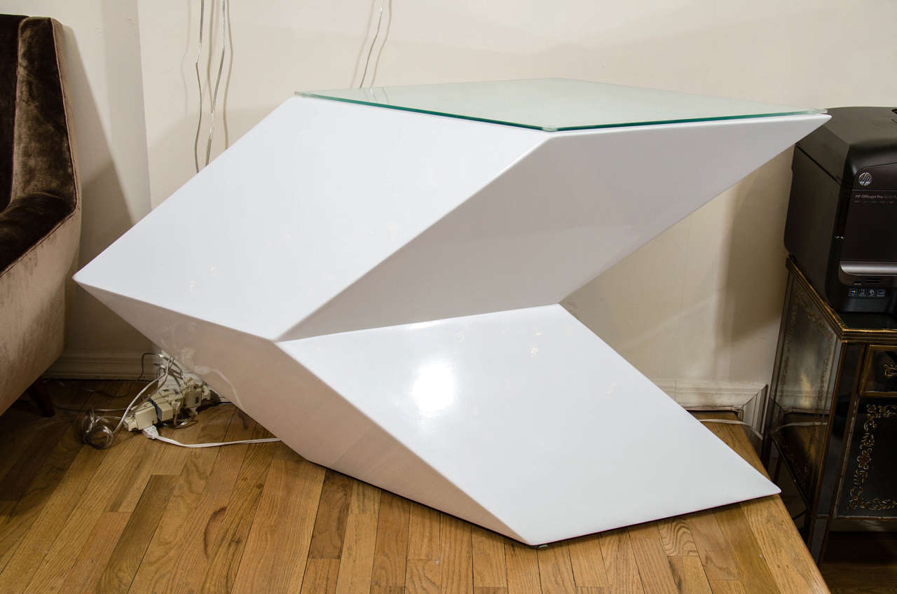 Angular cantilevered white lacquered wood console with glass top.