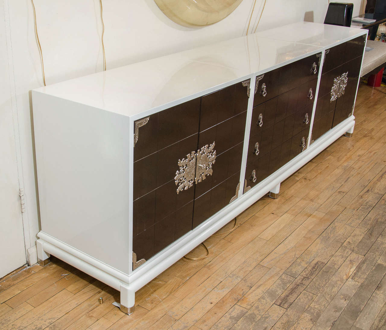 Asian inspired white lacquered wood sideboard with lacquered doors, drawers and decorative nickel hardware by Renzo Rutili.