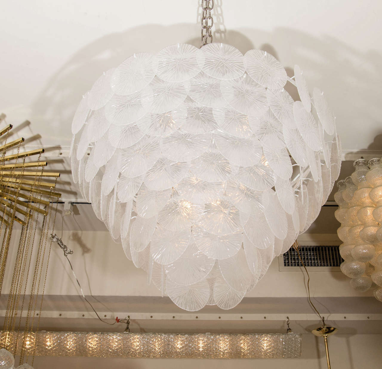 Multi-tiered chandelier composed of clear textured glass disks.