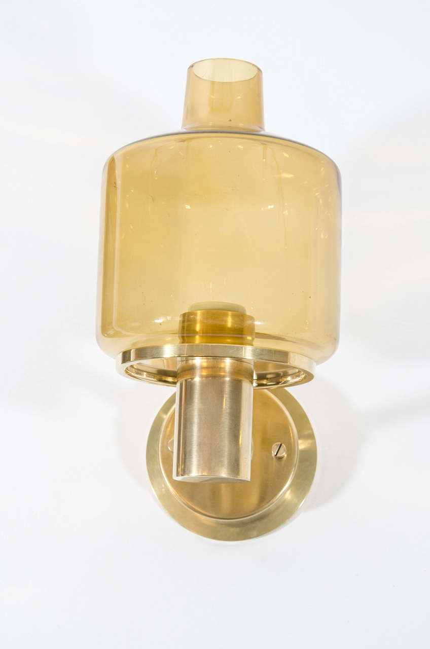 Pair of brass sconces by Hans-Agne Jakobsson sconces with original amber glass shades.