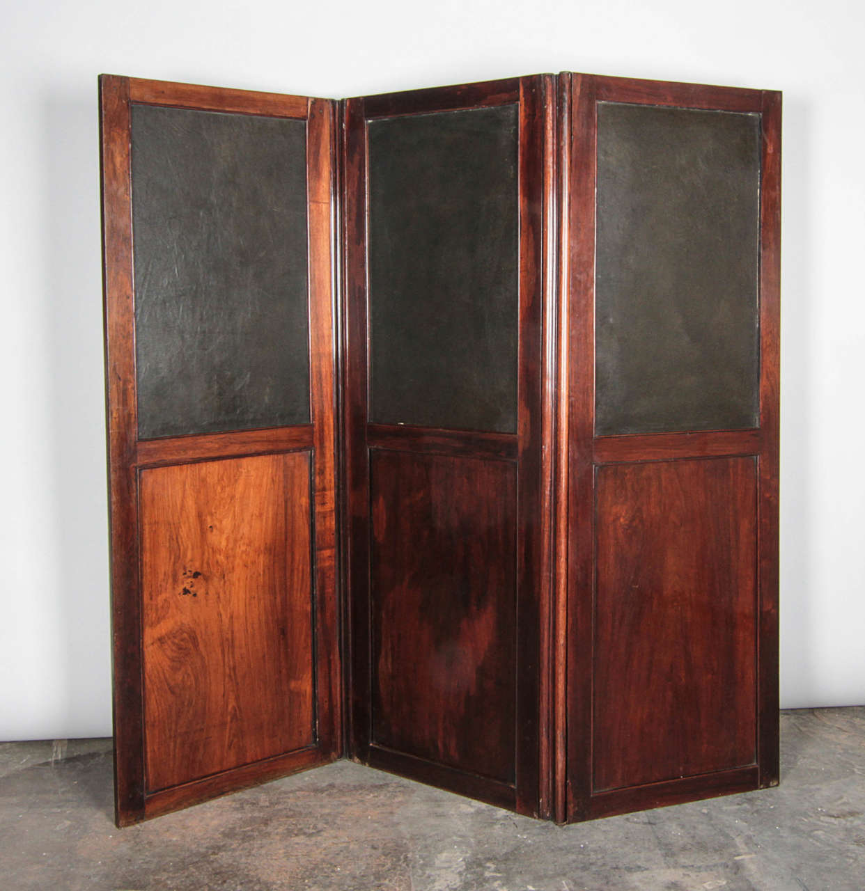 Vintage wood screen with leather inserts. Portions of the wood framing that lock the leather panels in place have fallen off with age. Still a completely functional piece that folds flat.

Not available for sale or to ship in the state of